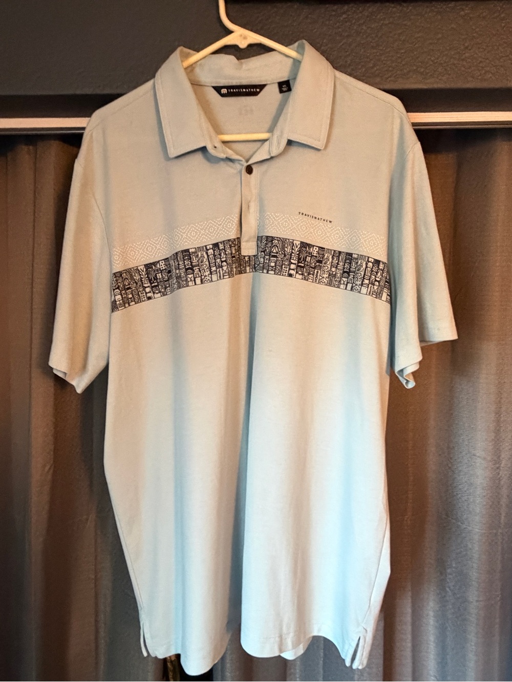 Travis Mathew Light Blue Polo with Navy Graphic Chest Stripe